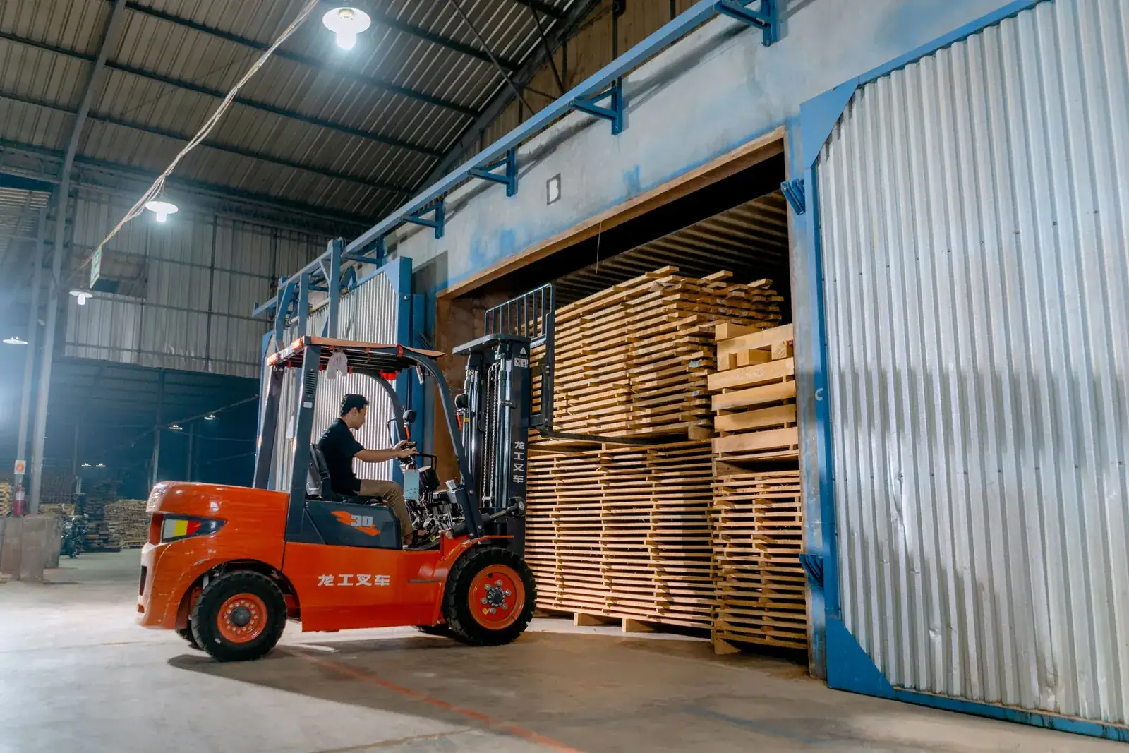 Forklift loading pallets into a container